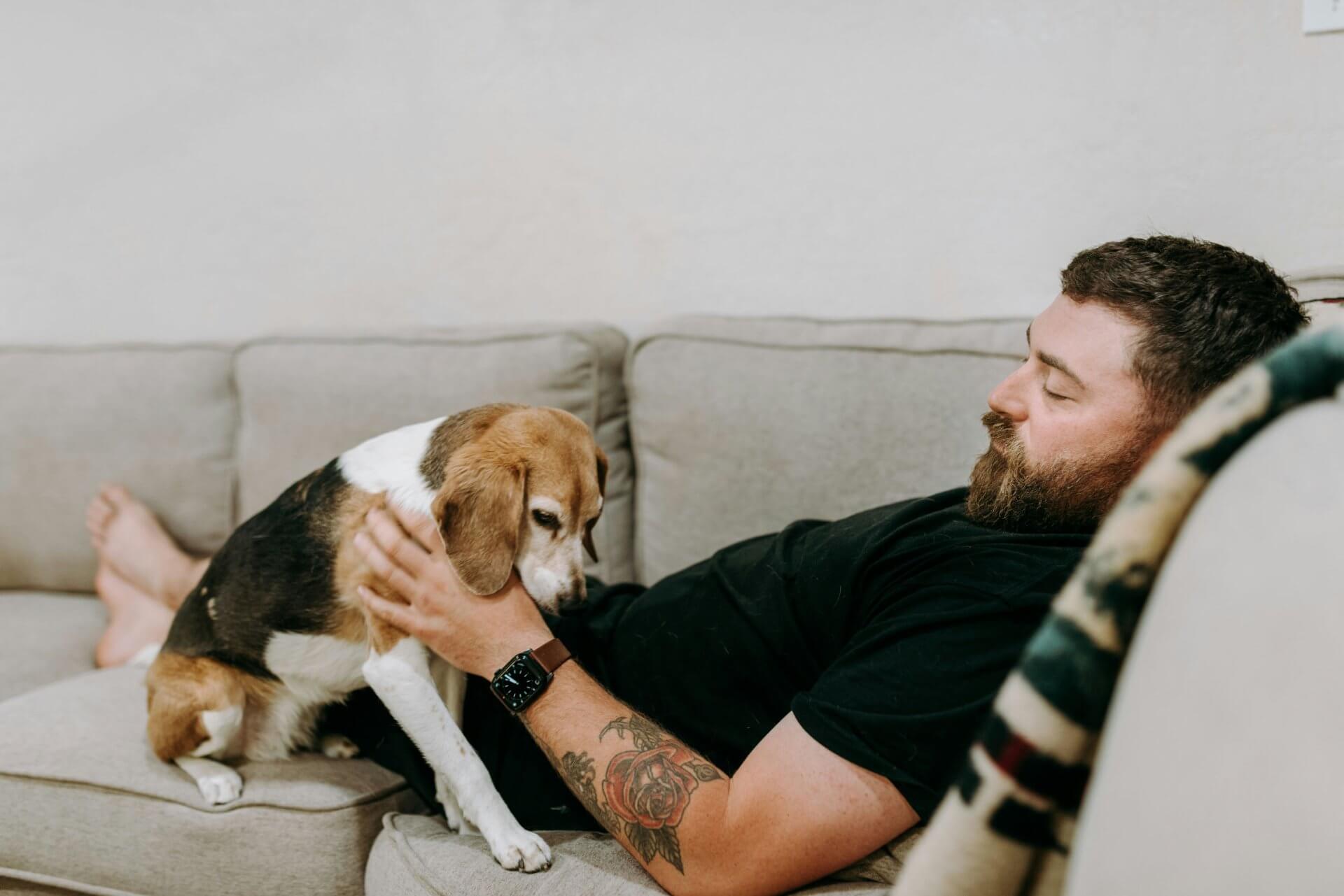 man and a dog on a couch at pet-friendly apartments in atlanta